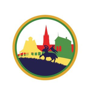 round gold outlined Logo depicting a lamb with a flag and a skyline of a church, butter cross and town hall building 